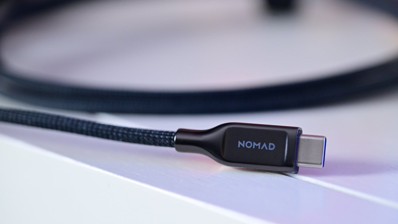 Close-up of a braided USB-C cable on a white surface, featuring the brand name Nomad.